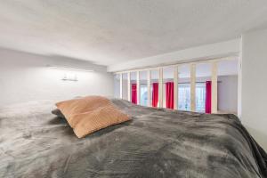 a bedroom with a large bed with a pillow on it at Golden Gate by Loft Apartments in Gdańsk