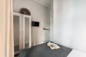 a bedroom with a bed and a book on the floor at Golden Gate by Loft Apartments in Gdańsk