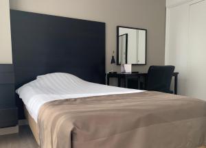 Postel nebo postele na pokoji v ubytování City Hotel Bergen op Zoom