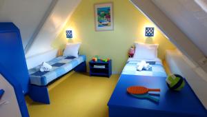 a childs bedroom with two beds and a table at VVF Les Plages de Guérande La Turballe in La Turballe +26 photos