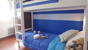 a bedroom with a blue and white bunk bed at VVF Haute Provence in Lagrand +39 photos