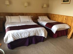 Voodi või voodid majutusasutuse Port Askaig Hotel toas
