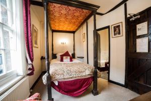 a bedroom with a large bed and a large window at Mermaid Inn in Rye