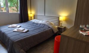 a bedroom with a bed with two towels on it at VVF Lège Cap Ferret in Lège-Cap-Ferret +25 photos