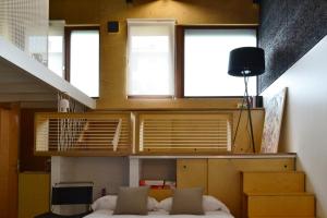 a bedroom with a bed in a room with windows at ATERIAN LOFT 2 in Zarautz