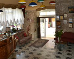 a living room with a couch and a table at Hotel Stockholm in Lido di Jesolo