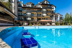a swimming pool in front of a hotel at Premier Luxury Mountain Resort in Bansko