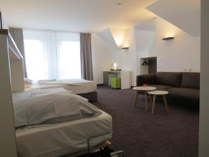 Postel nebo postele na pokoji v ubytování Comfor Hotel Ulm City