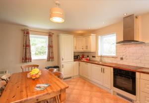 a kitchen with a wooden table with bananas on it at Ballybunion Cottages No 22 in Ballybunion