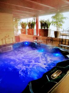 a jacuzzi tub in the middle of a patio at Hotel Dolce Vita in Balatonkenese