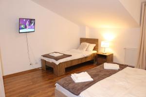 En eller flere senge i et værelse på Timisoara City Apartments