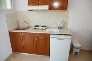 a kitchen with a sink and a counter top at Villa Thomas Valtos beach in Parga