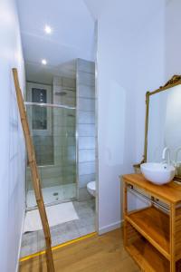 a bathroom with a glass shower and a sink at F3 - Standing Centre Ville Calme Et Climatise in Ajaccio