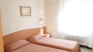 Postel nebo postele na pokoji v ubytování Albergo Moretti