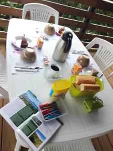 a white table with food and bread on it at Ti Kaz Lontan in Salazie