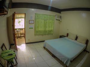 Cama o camas de una habitación en Remari Tourist Inn