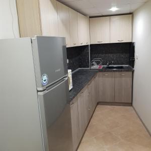 a kitchen with a refrigerator and a sink at Guest rooms Super center PLOVDIV perfect location in Plovdiv