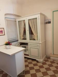 a kitchen with a large white hutch at Casa Lulù in Minori