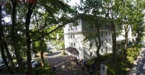 a large white building on the side of a street at Gästehaus DEULA in Warendorf