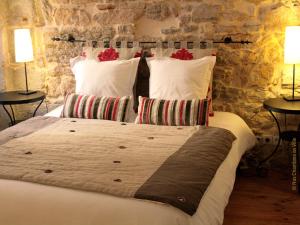 a bedroom with a large bed with two lamps at Nos chambres en ville B&B in Lyon