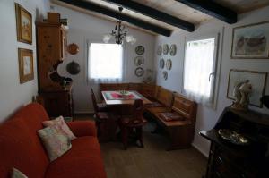 a living room with a red couch and a table at Haus Judith in Steindorf am Ossiacher See