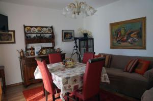 a living room with a table and a couch at Haus Judith in Steindorf am Ossiacher See +4 photos