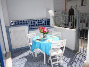 a table with a vase of flowers on a balcony at Le Case dei Pescatori - La Suite in Ponza