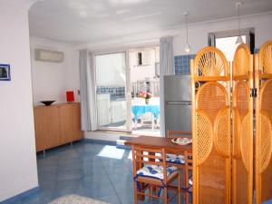 a kitchen and dining room with a table and a refrigerator at Le Case dei Pescatori - La Suite in Ponza