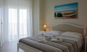 a bedroom with a bed with two towels on it at Vilu Suite Mare in Polignano a Mare