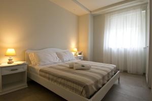 a bedroom with a bed with a hat on it at Vilu Suite Mare in Polignano a Mare