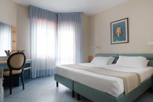 Postel nebo postele na pokoji v ubytování Hotel Monaco & Quisisana