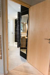 a door leading into a bathroom with a sink at Homgaïa chambres d'hôtes in Clisson