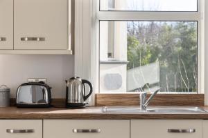 a kitchen counter with a sink and a window at Cyprus View Apartment 2 in Belfast