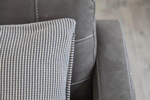 a close up of a gray couch with a pillow at Cyprus View Apartment 2 in Belfast