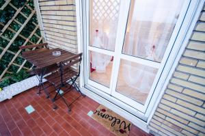 un porche con un banco junto a una ventana en Hello Rose - Appartamento intero, en Roma