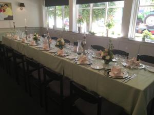 a long table in a room with chairs and a table cloth at Hotel Rødding in Rødding