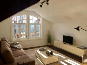 a living room with a couch and a tv at Casa Rosa Sousa in Felgueiras