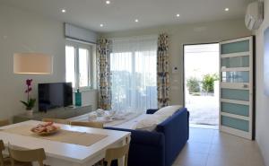 a living room with a couch and a table at Vilu Suite Mare in Polignano a Mare