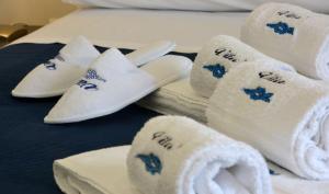 a pile of towels and towels on a bed at Vilu Suite Mare in Polignano a Mare