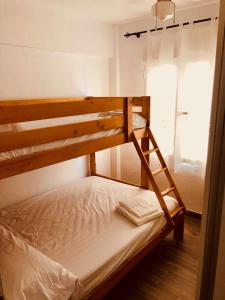 a bunk bed with a ladder in a room at Cabo de palos subida al faro in Cabo de Palos