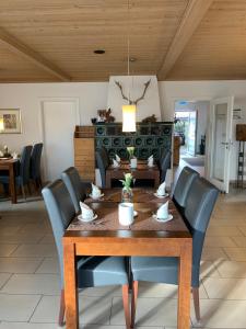 a dining room with a wooden table and chairs at Hotel Palko in Dingolfing