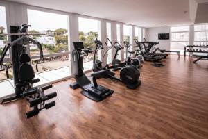 a gym with a bunch of treadmills and exercise bikes at Grupotel Rocador - Adults Only in Cala d´Or