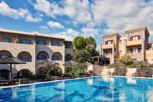 a pool at a hotel with chairs and umbrellas at Angelina Boutique Escape in Perdika
