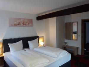 Postel nebo postele na pokoji v ubytování Hotel Luca