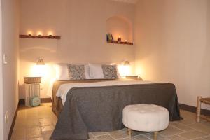a bedroom with a bed and a stool in it at Borgo San Gaetano in Bernalda