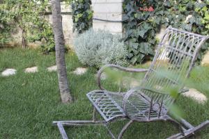 a bench sitting in the grass in a yard at Borgo San Gaetano in Bernalda