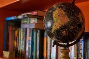 a globe on a stand in front of books at Galway City Hostel in Galway