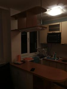 a kitchen with a table and a counter top at Flat, 1 room, study in Panevėžys