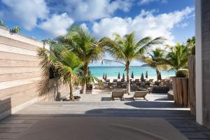 a resort with a view of the beach and palm trees at Pearl Beach Hotel in Gustavia