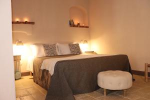 a bedroom with a bed and a chair in it at Borgo San Gaetano in Bernalda